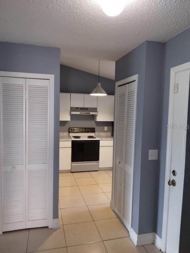 kitchen with white cabinetry, light tile patterned floors, range with electric stovetop, and pendant lighting