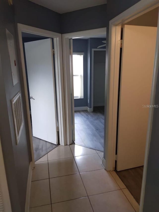 corridor featuring light tile patterned floors