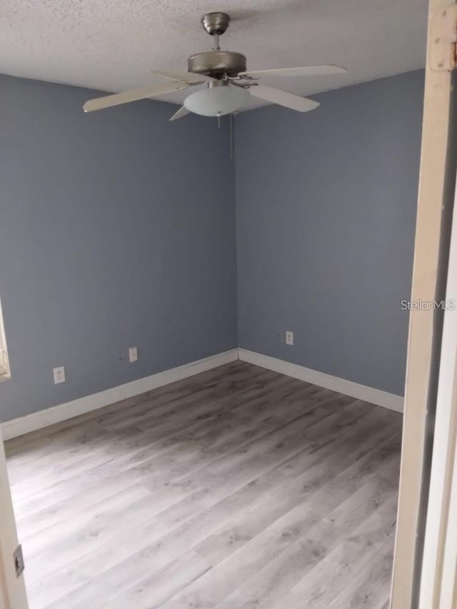 unfurnished room featuring ceiling fan, a textured ceiling, and light hardwood / wood-style floors