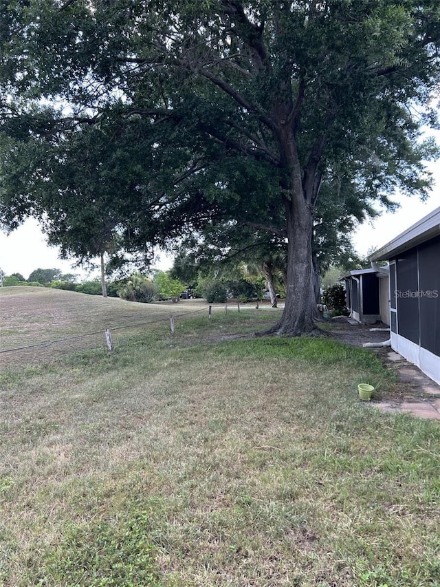 view of yard featuring a sunroom