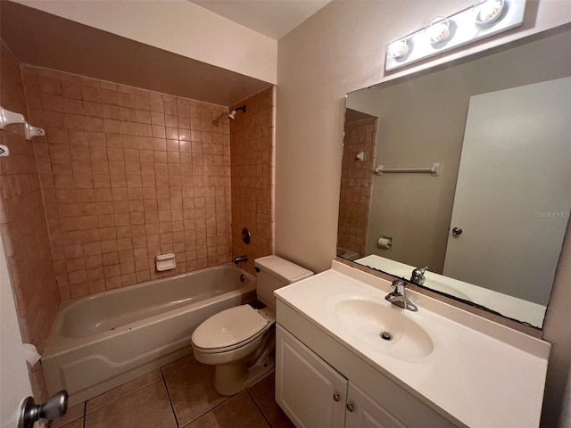 full bathroom featuring tile patterned flooring, vanity, tiled shower / bath combo, and toilet