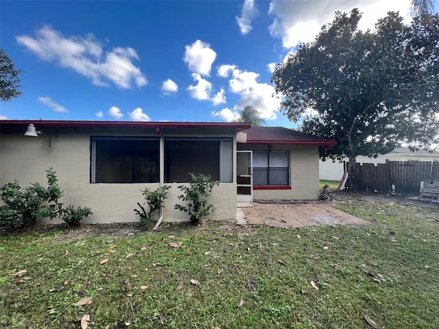 rear view of house with a yard