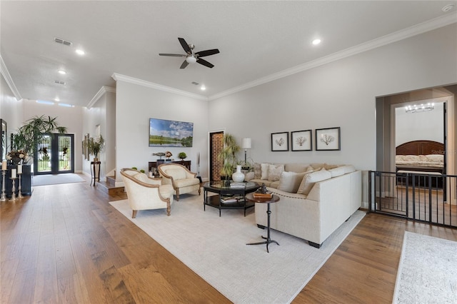 living room with ceiling fan, french doors, wood-type flooring, and ornamental molding