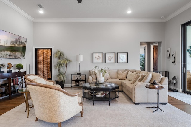 living room featuring light hardwood / wood-style floors and ornamental molding