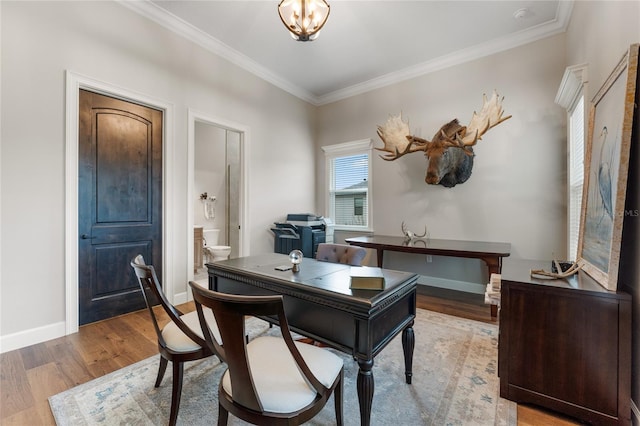 office space with ornamental molding and light wood-type flooring