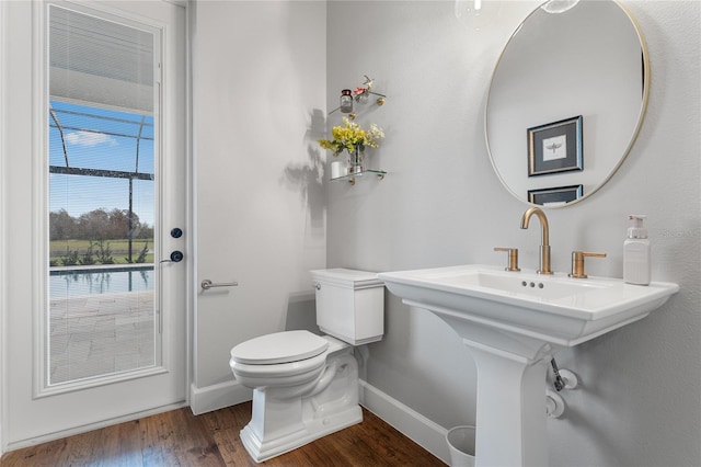 bathroom with hardwood / wood-style flooring, toilet, and sink