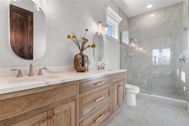 bathroom with vanity, toilet, and walk in shower