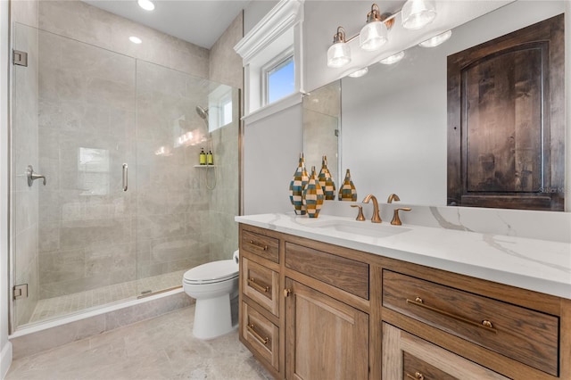 bathroom with tile patterned floors, vanity, an enclosed shower, and toilet