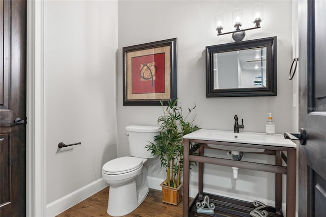 bathroom featuring hardwood / wood-style floors, toilet, and sink