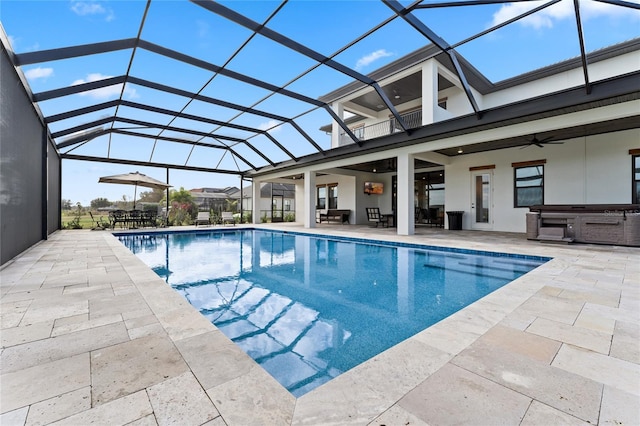 view of pool with a patio, ceiling fan, and a lanai