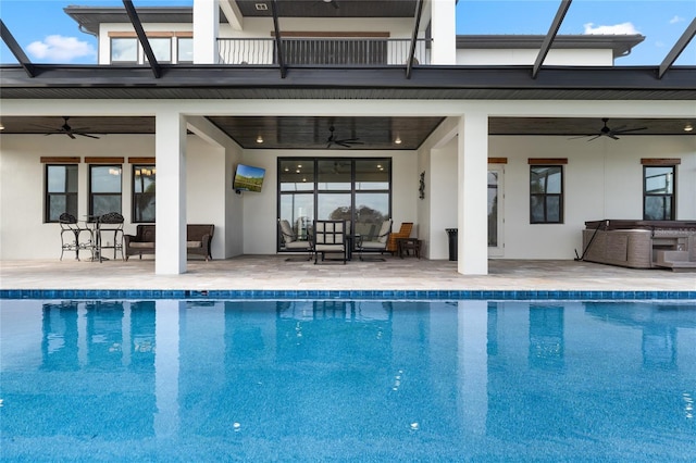 view of swimming pool featuring a hot tub, ceiling fan, and a patio area