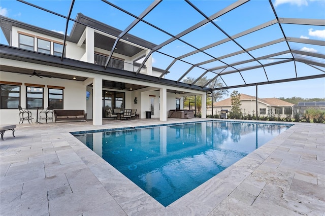 view of swimming pool with a lanai, ceiling fan, and a hot tub