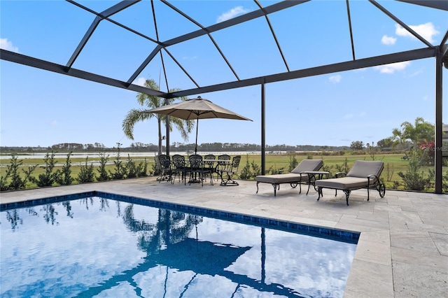 view of swimming pool with glass enclosure and a patio area