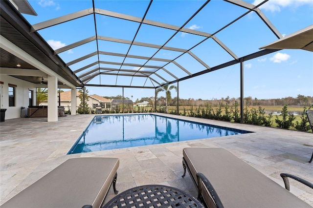 view of pool with a lanai, a patio area, and ceiling fan