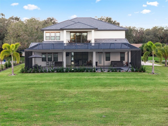 rear view of house with a patio, a lanai, and a lawn