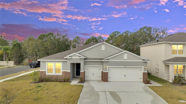 view of front of house with a garage and a lawn