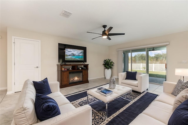 living room featuring light tile patterned floors and ceiling fan