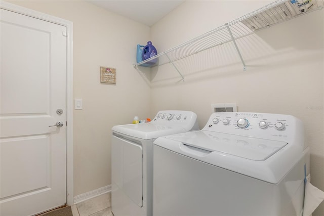 washroom featuring tile patterned flooring and separate washer and dryer