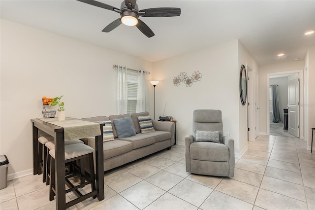 tiled living room with ceiling fan