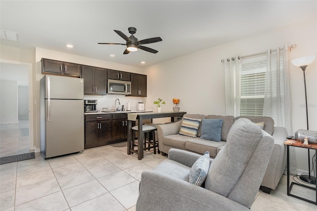 tiled living room featuring ceiling fan