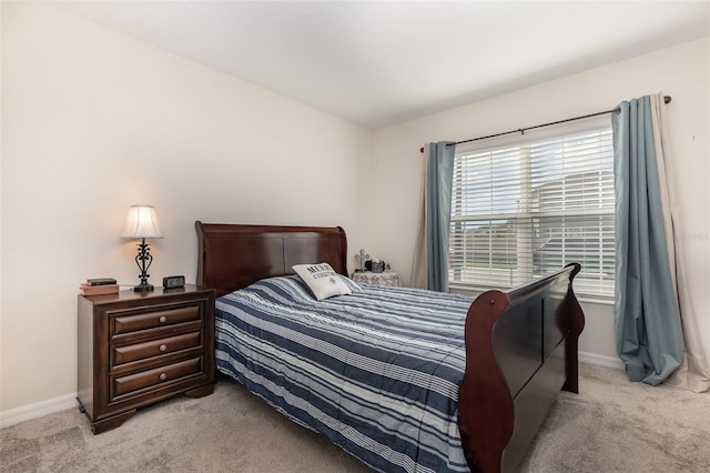 bedroom featuring light colored carpet