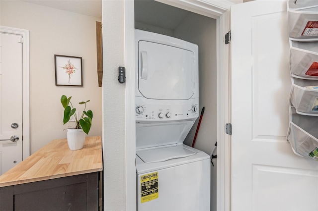 laundry area featuring stacked washer / drying machine