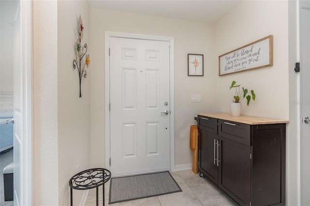 doorway featuring light tile patterned floors