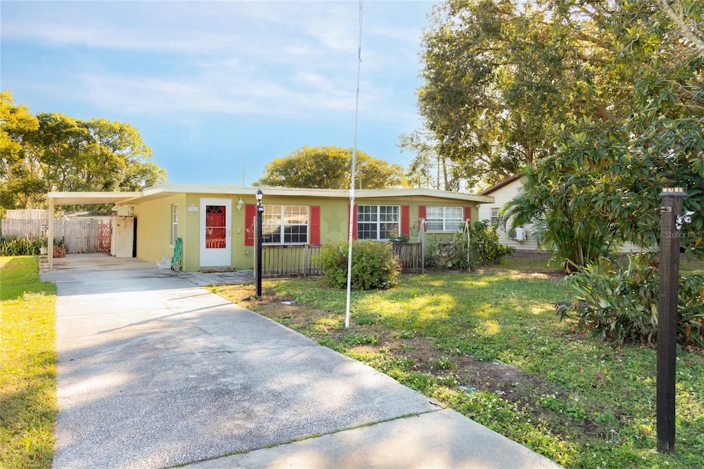 single story home featuring a front lawn and a carport