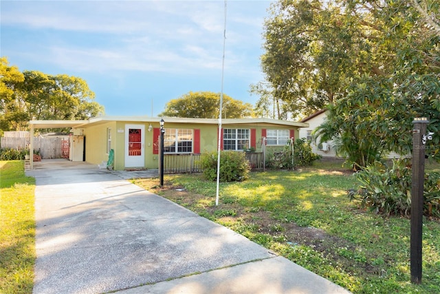 single story home featuring a front lawn and a carport