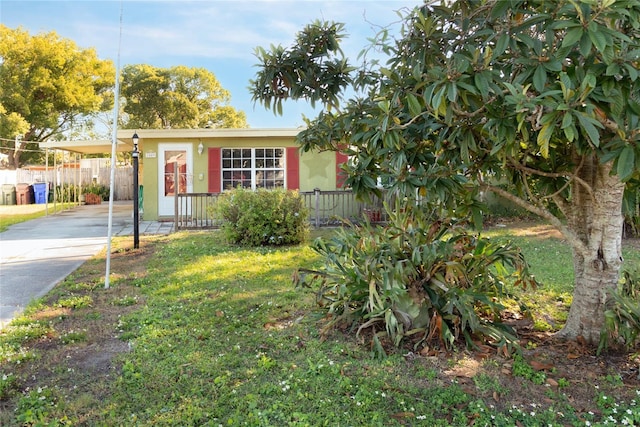 view of front of house with a front lawn and a carport