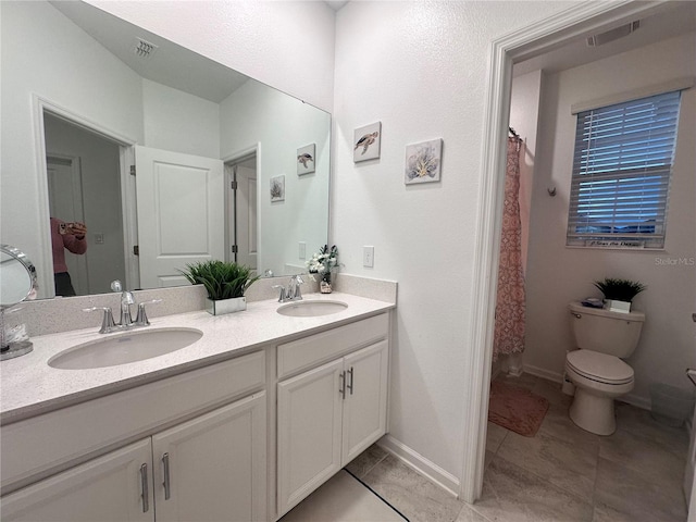 bathroom featuring toilet, vanity, tile patterned floors, and a shower with shower curtain