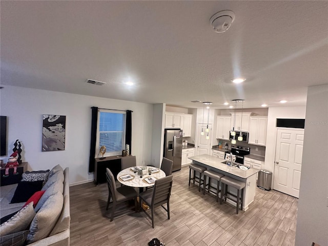 dining area with light hardwood / wood-style flooring