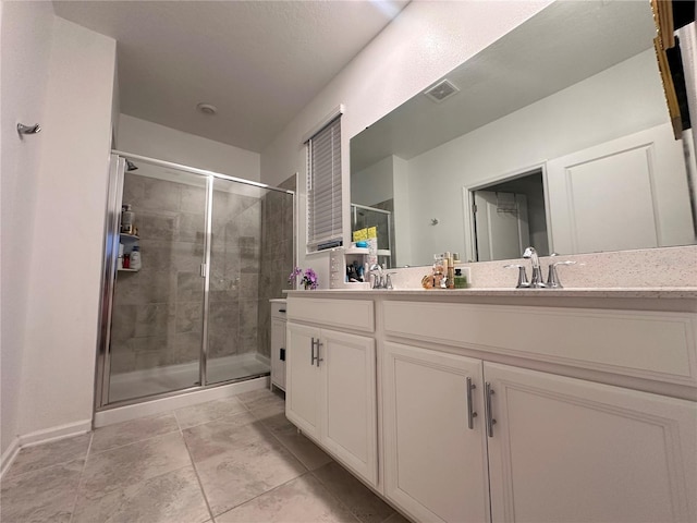 bathroom with vanity and a shower with door