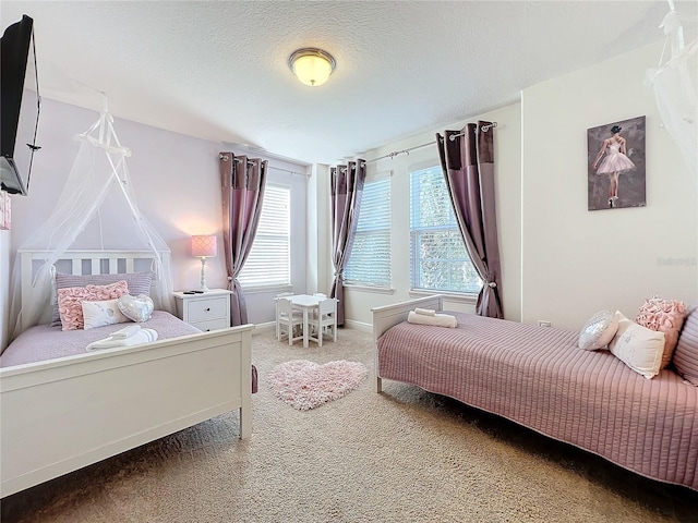 bedroom featuring carpet and a textured ceiling