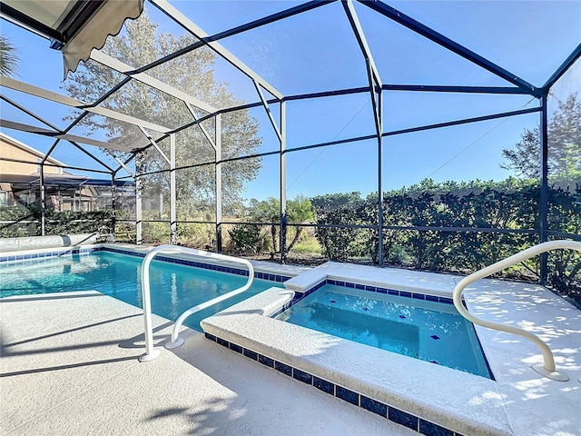 view of pool with an in ground hot tub, glass enclosure, and a patio area