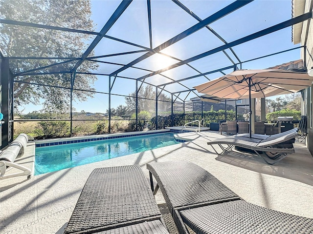 view of swimming pool with glass enclosure and a patio