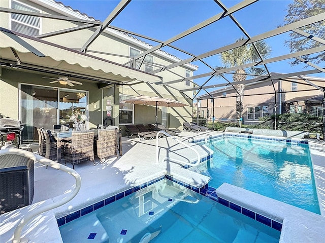 view of swimming pool featuring glass enclosure, ceiling fan, and a patio area