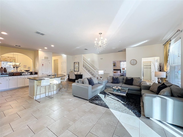 tiled living room featuring an inviting chandelier and sink