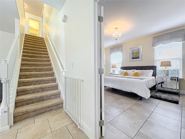 staircase with an inviting chandelier