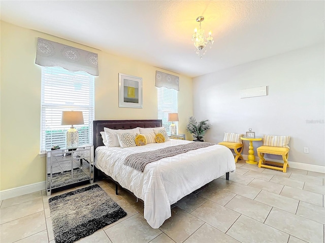 tiled bedroom with an inviting chandelier