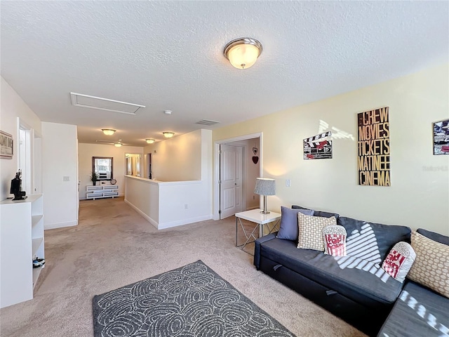 living room featuring light colored carpet and a textured ceiling