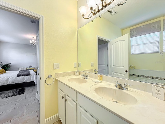 bathroom featuring vanity, tile patterned floors, and a notable chandelier