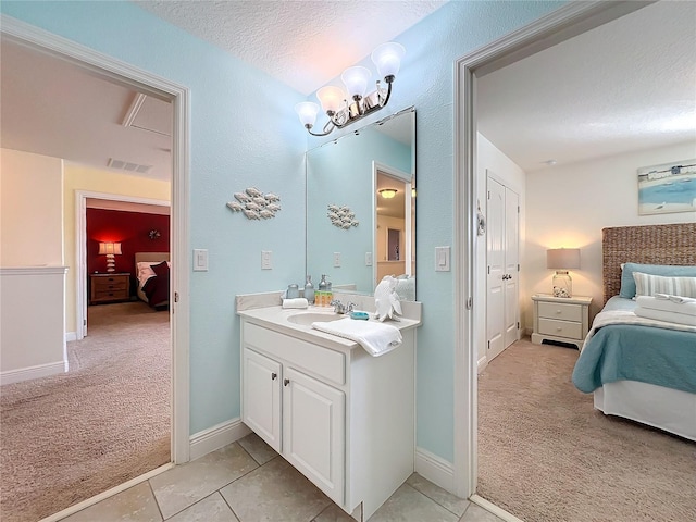 bathroom featuring vanity, a textured ceiling, a chandelier, and tile patterned flooring