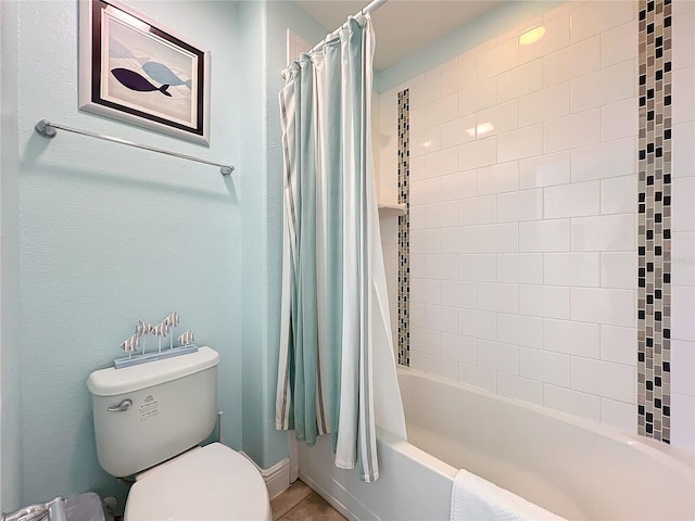 bathroom featuring shower / tub combo and toilet