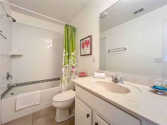 full bathroom featuring vanity, tile patterned flooring, toilet, a textured ceiling, and shower / tub combo