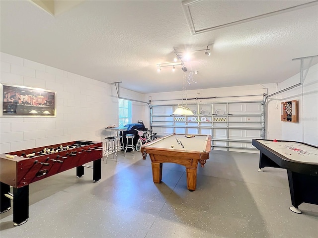 playroom with a textured ceiling and billiards