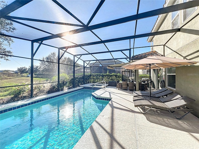 view of swimming pool with a lanai, an in ground hot tub, and a patio