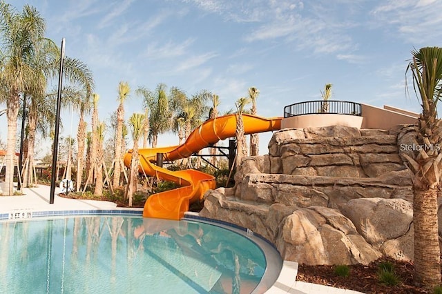 view of pool with a water slide