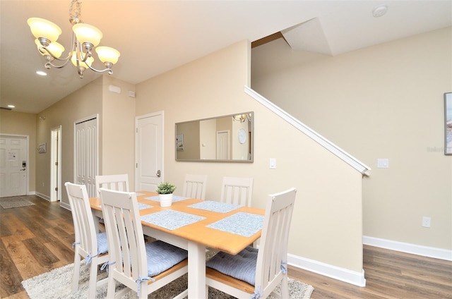 dining room with a chandelier and dark hardwood / wood-style floors