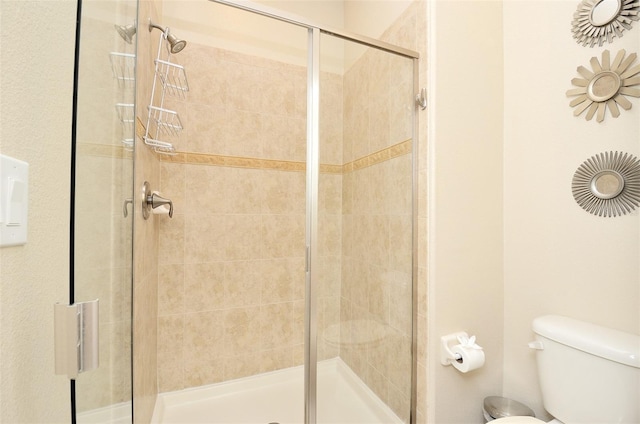 bathroom with toilet and walk in shower